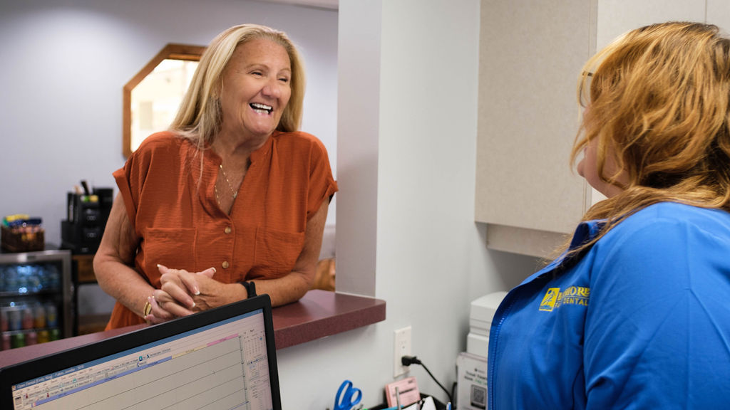 patient smiling at receptionist