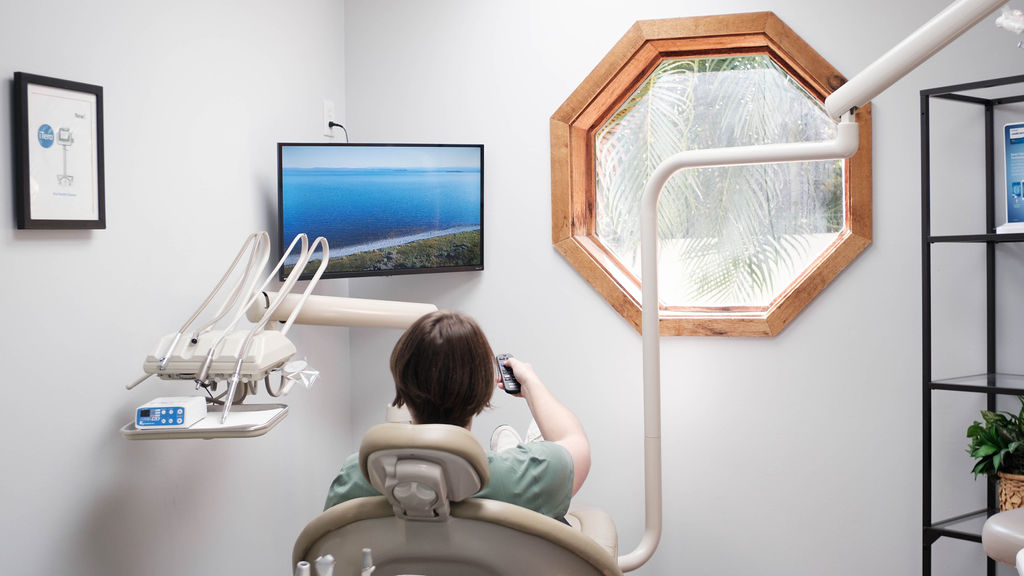 Patient in dental room clicking a remote